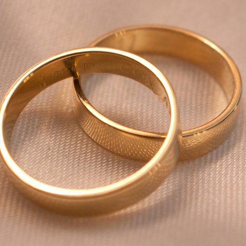 gold ring on white textile