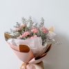 bouquet of flowers on brown wooden table